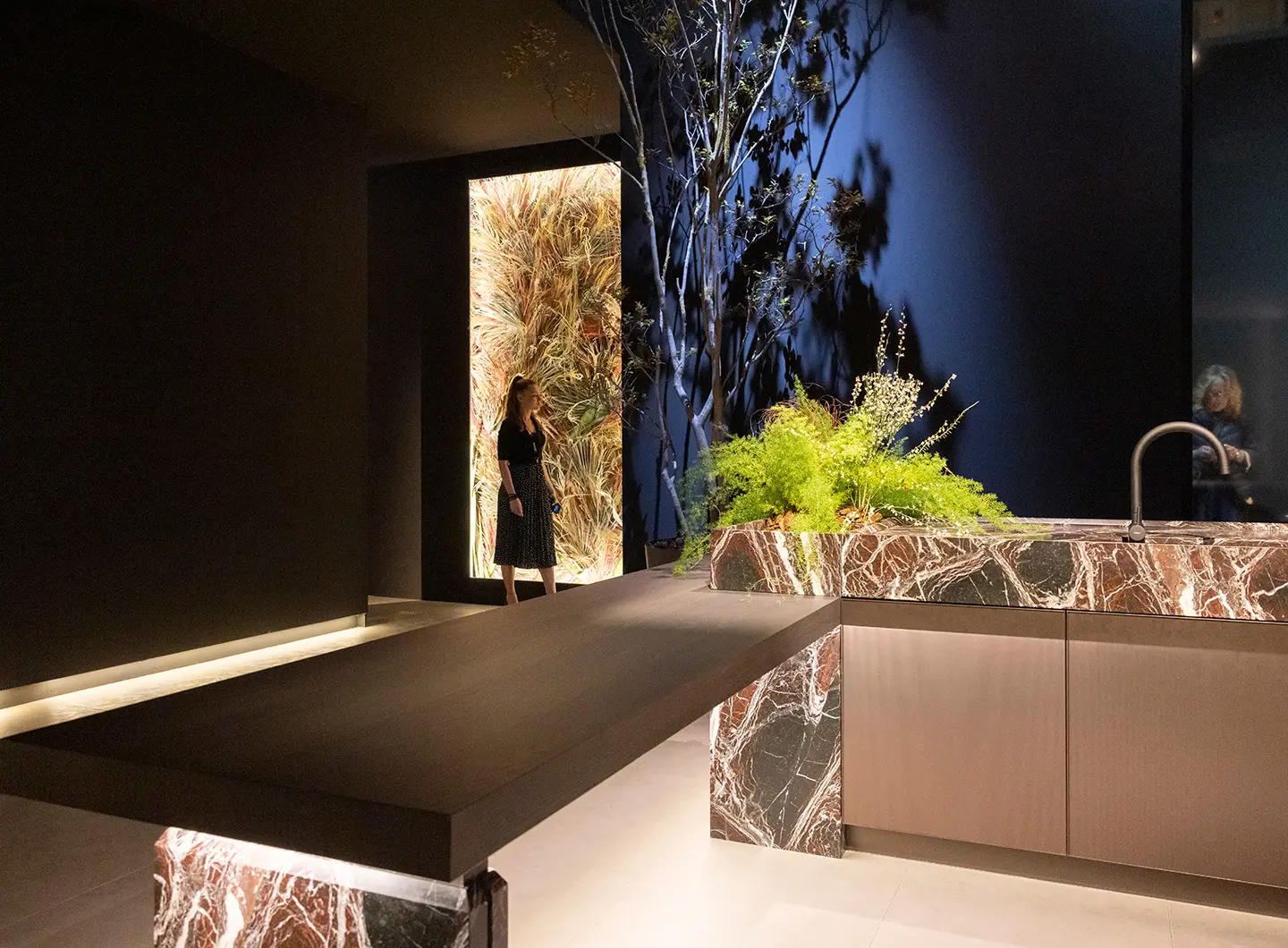 Part of a marble kitchen with an attached dark wood table