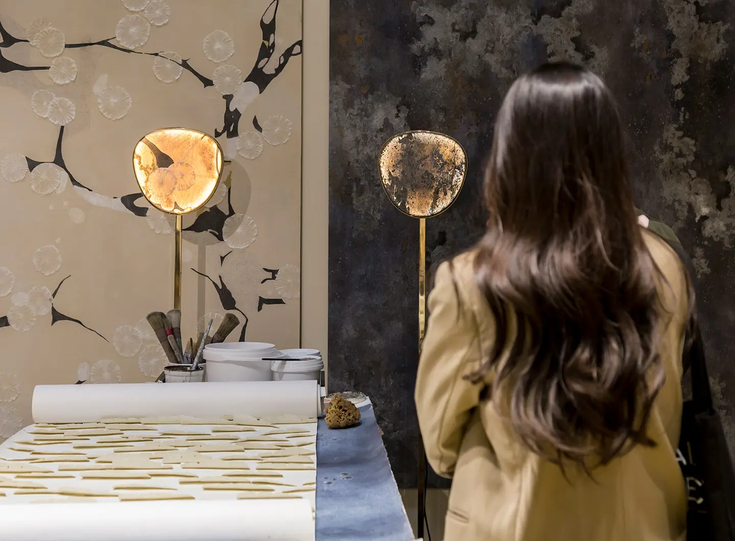 Girl from behind looking at hand-painted wallpapers inspired by art and nature