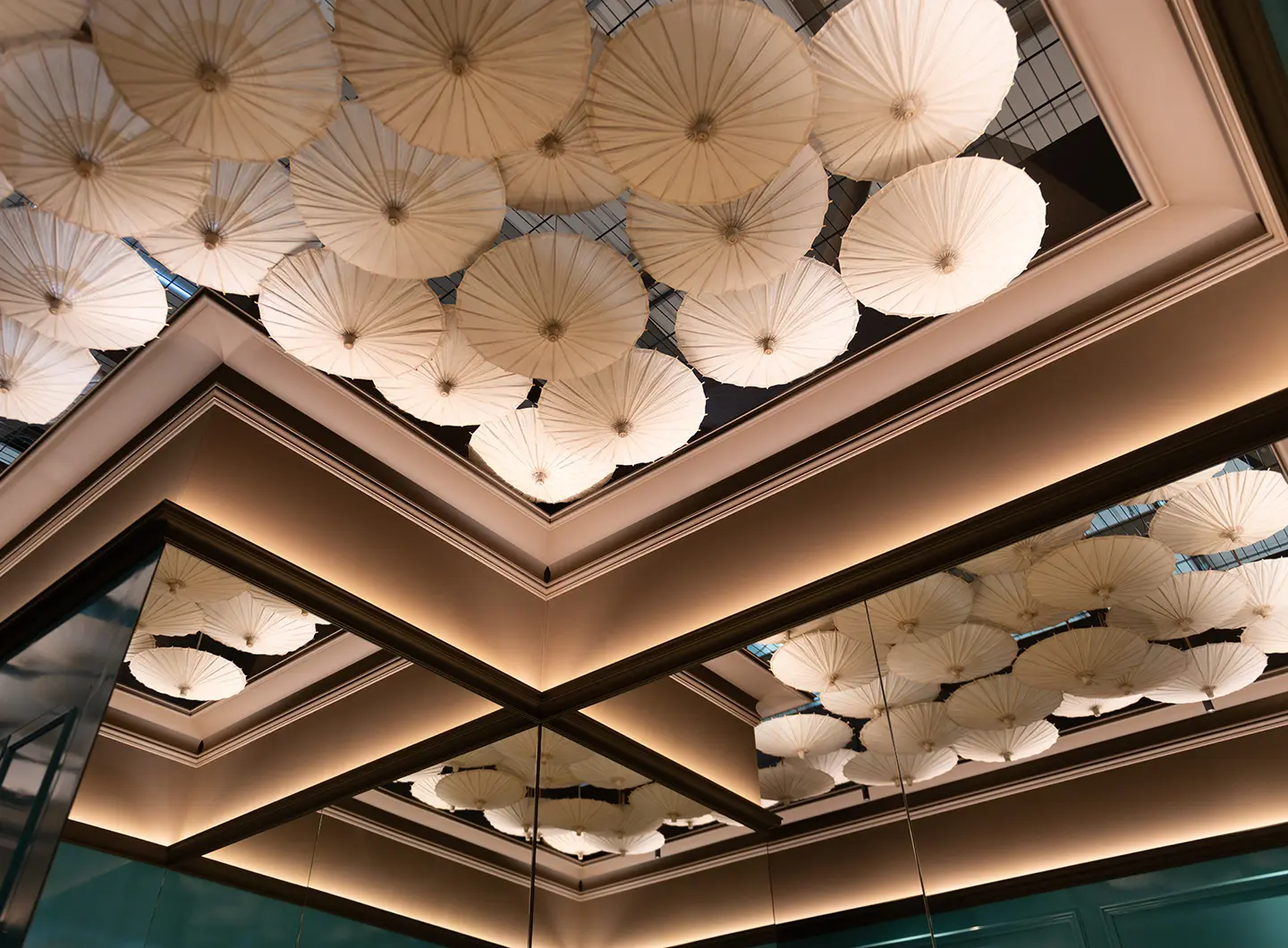 Coving frame and decoration of paper umbrellas hanging upside down from the ceiling