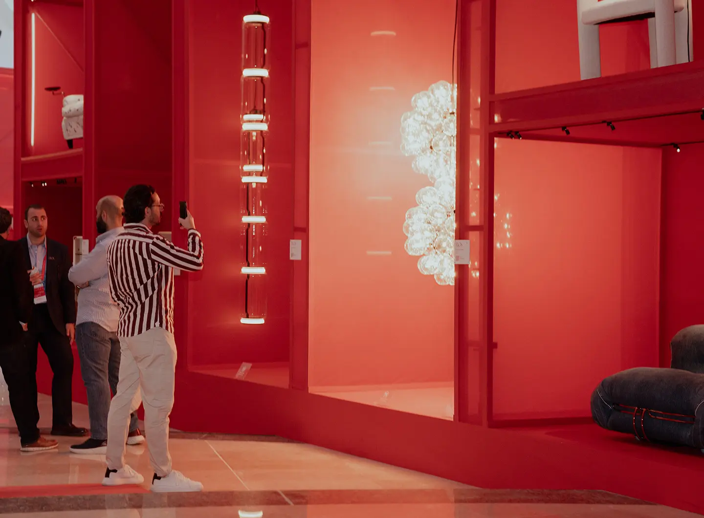 Red in progress, installation Giò Forma, with visitors viewing the products