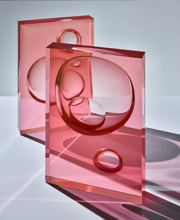 Resin panels with spherical forms carved from behind, bending and concentrating light through a natural lensing effect. 