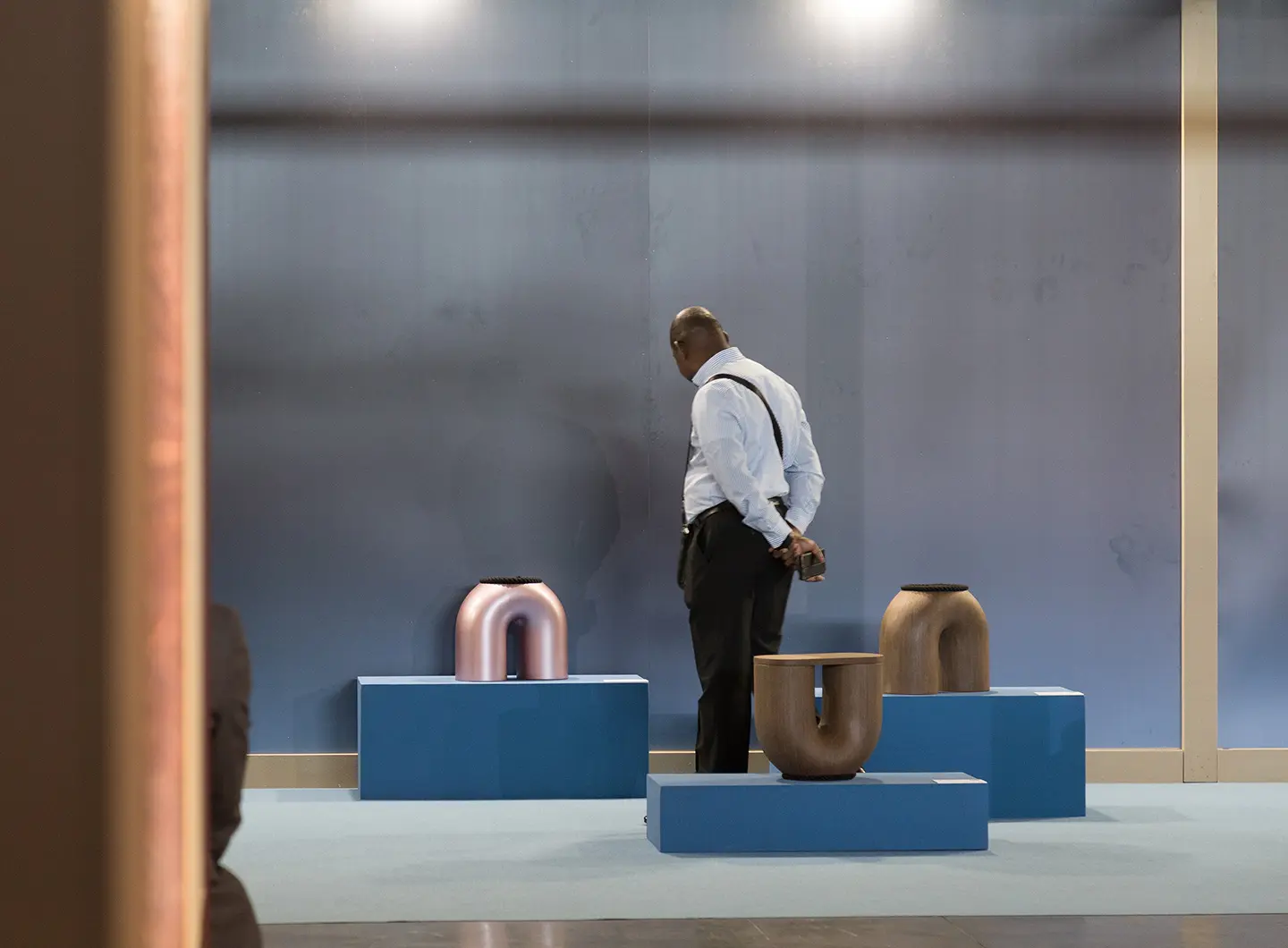 Vistor looking at metal stools and coffee tables